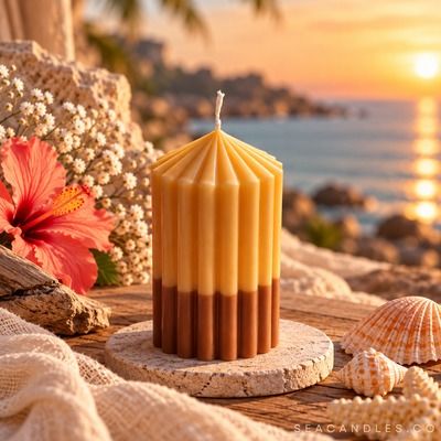 Caramel Drip — cream and caramel brown pillar candle at sunset with hibiscus and seashells